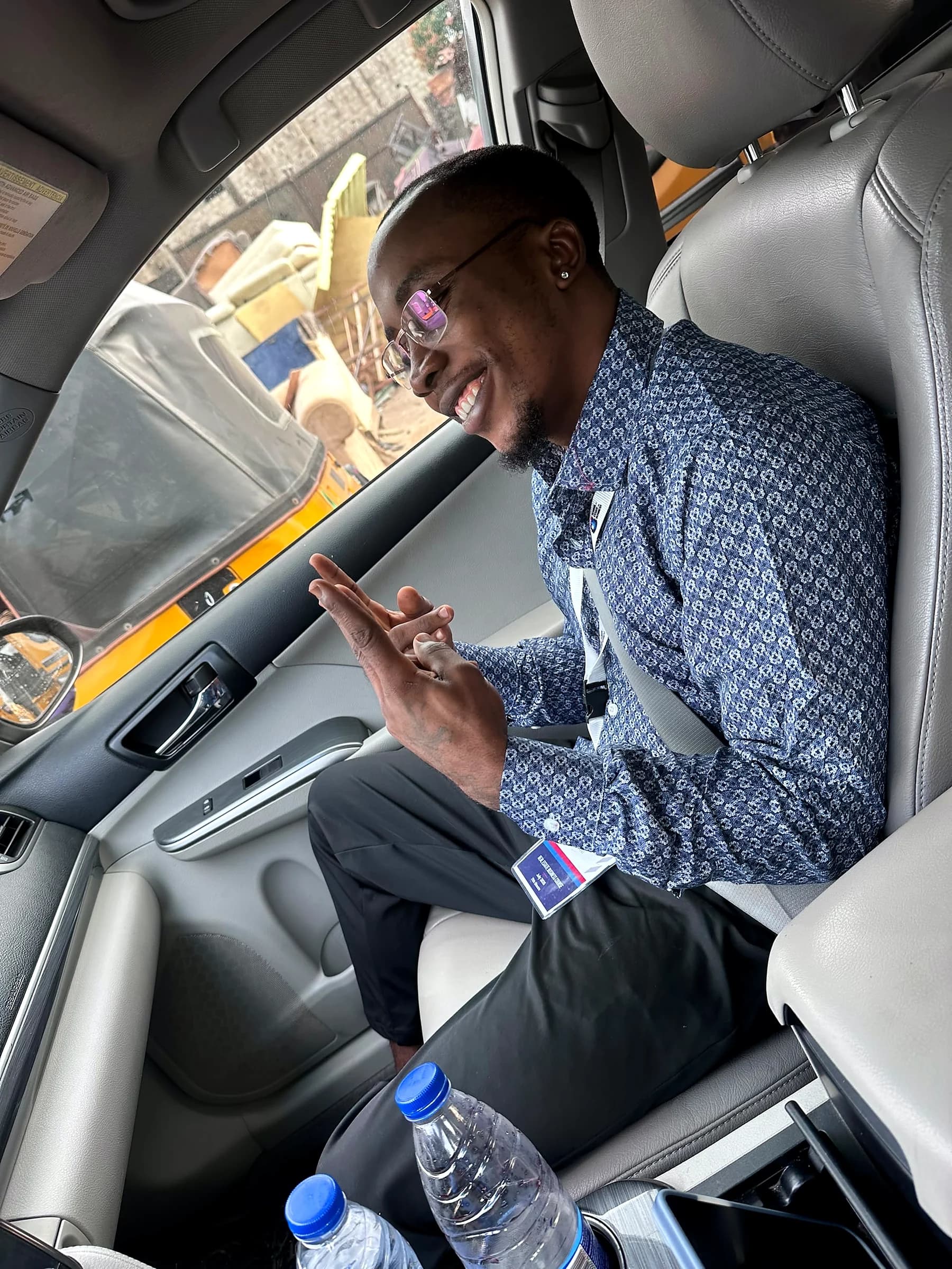 Tahnwi Lesley reviewing his phone while travelling